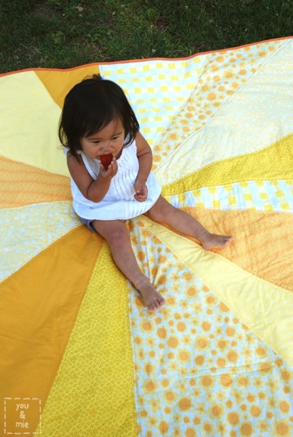 "Sunburst Picnic Blanket" is a Free Picnic Quilt Pattern designed by Cherie from You and Mie!